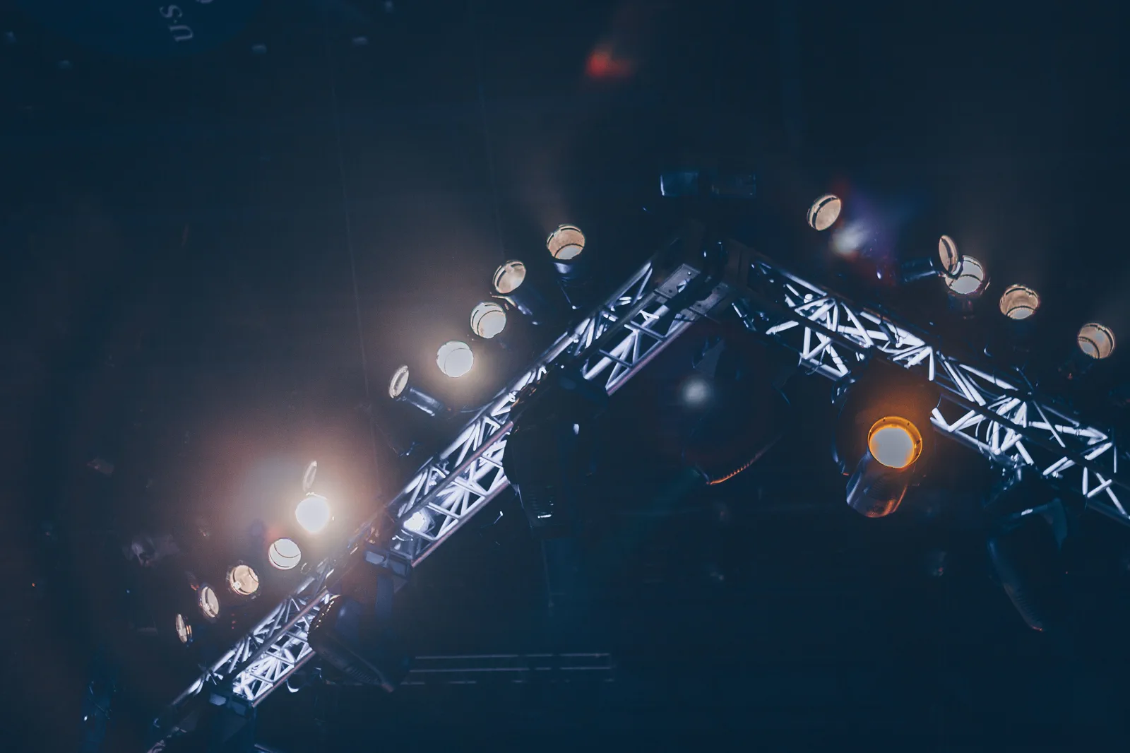 Stage lighting rig with moving heads and trussing set up for a live event