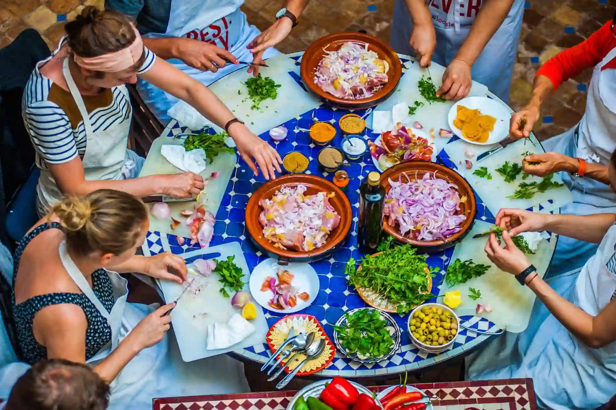 Hands kneading bread and rolling pastry at a Marrakech cooking class