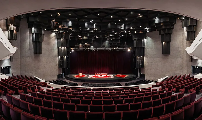 Tiered auditorium seating and stage inside a Marrakech congress centre, set for a plenary session
